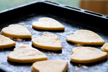 the dough in the shape of a heart for Valentine's Day. on a black background.The concept of the Valentine's Day holiday.