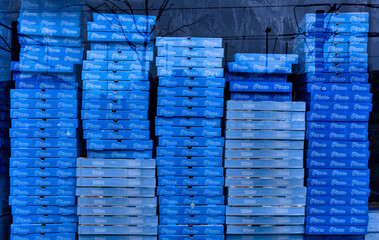 Stacked pizza boxes in a shop window