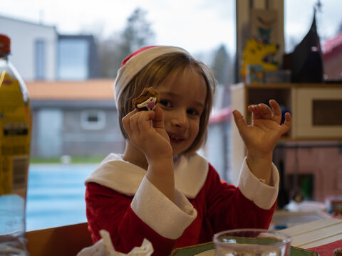 Little girl dressed as Santa Claus.