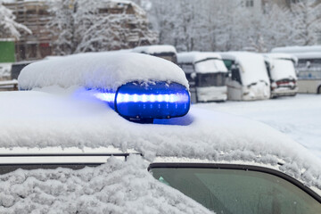 daylight. police siren blue under the snow. Close-up.
