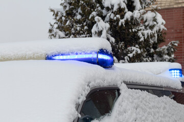 daylight. police siren blue under the snow. Close-up.