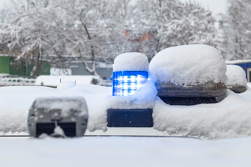 daylight. police siren blue under the snow. Close-up.