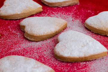Heart-shaped cookies decorated for Valentine's Day.Cookies on a red background.The concept of the Valentine's Day holiday.