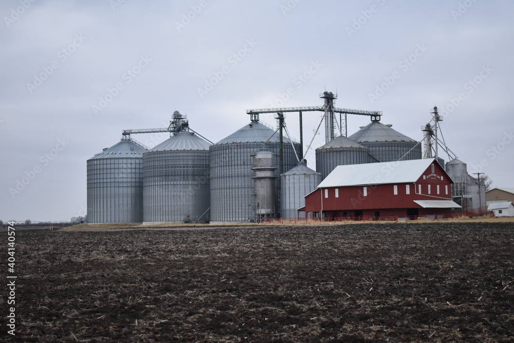 Sticker grain bins and a barn