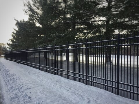 Wrought Cast Iron Fence Gate In The Winter Snow In Front Of Charles River Labs, Shrewsbury, MA Massachusetts USA