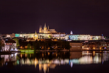 Fototapeta na wymiar Prague in the evening with colorful lights and reflection in the river