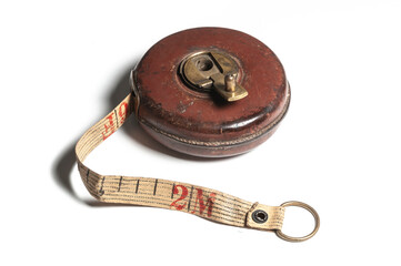 Vintage tape measure in leather casing on white background