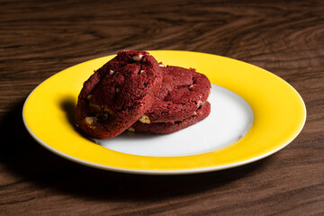 Red Velvet cookie with white chocolate on the dark wooden table