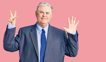 Senior grey-haired man wearing business jacket showing and pointing up with fingers number eight while smiling confident and happy.