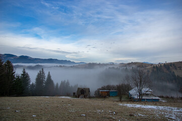 Fototapeta na wymiar Fog morning in the mountains in the village