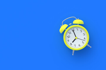 Single yellow vintage analog alarm clock on blue background. Wake-up concept. Punctuality. Countdown and deadline. Daily regime. Business planning. Top view. Copy space. 3d rendering