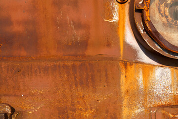 Rusty metal sheet close up. The empty background is a rusty orange color. - 404152397