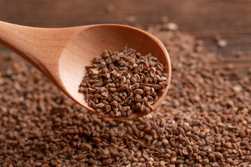 Wooden spoon with anise seeds. Anise in a spoon close-up.