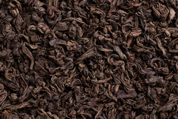 Black tea leaves close up. Large tea leaves. Tea background. Tea leaves.