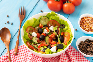 Delicious Greek salad of fresh tomatoes, cucumbers and herbs with feta cheese.