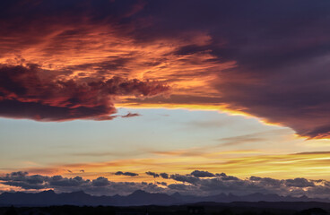 Fototapeta premium Dramatic Sunset with mountains in the distance