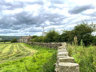Fototapeta na wymiar Rural view near, Bents Lane, with a freshly cropped field, and a farm in, Queensbury, Bradford, UK