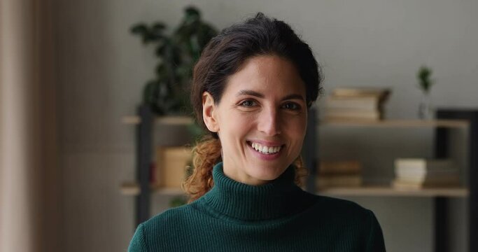 Head shot lady has brown combed hair, appealing appearance, wear casual green turtleneck look at camera. Millennial generation 30s woman portrait, satisfied client and professional services ad concept