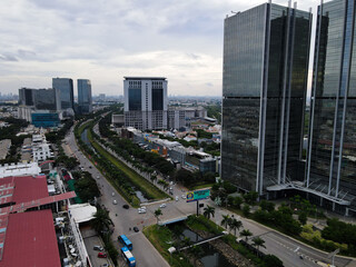 Aerial view of office buildings in Jakarta central business district and noise cloud when sunset. 