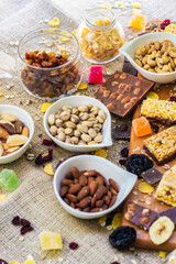 Granola Bars and mixed nuts. Honey bars with peanuts, chocolate, dried fruit, sesame and sunflower seeds