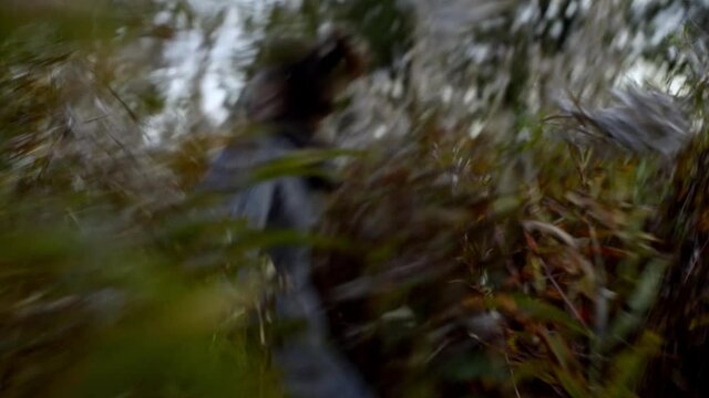 Moving and dynamic frame with young and happy woman running through the meadow.