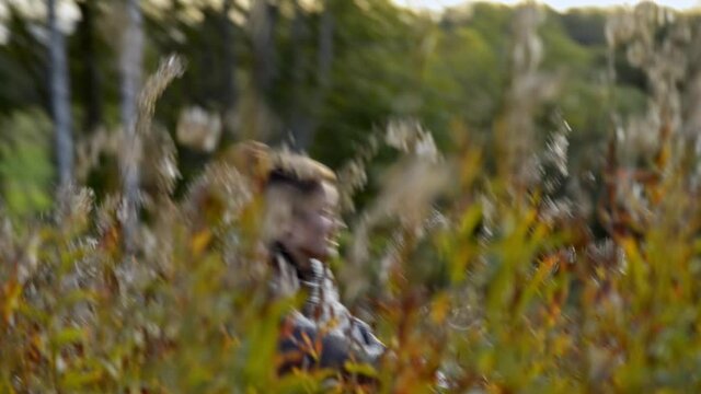 Scared female running fast through the golden meadow