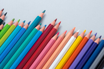Colorful pencils in the case isolated on the gray background.