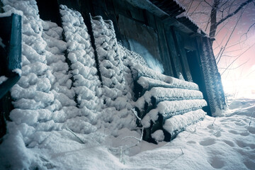 the wall of the wooden barn in the snow