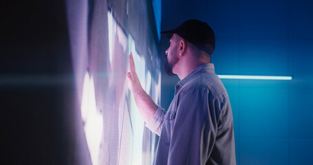 Male technician examining LED screen