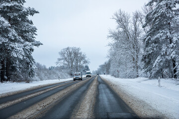 Fototapeta na wymiar Country road after snowfall in Lithuania