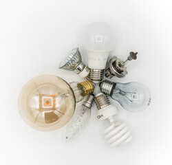 Many types of light bulbs on a white background and these are LED, spiralfluorescent, incandescent,...