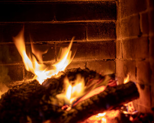 tongues of fire in a heated stone fireplace, horizontal