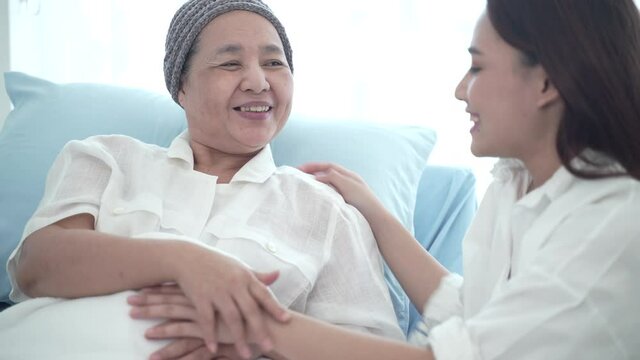 senior cancer patient have a hug with her daughter, young woman visits her mother at the hospital, older people healthcare support concept