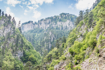 Fototapeta na wymiar Perspective view at rocky slopes of mountains