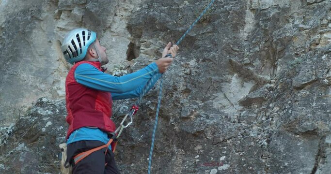 Rock climber putting on his equipment