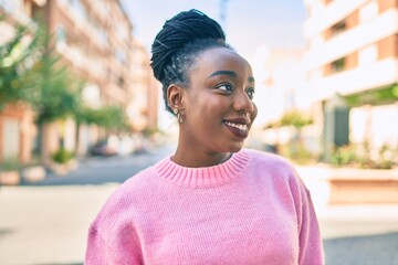 Fototapeta premium Young african american woman smiling happy walking at the city.