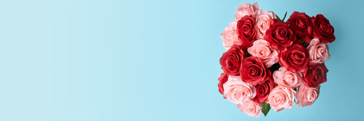 artificial red and pink roses in blue background to celebrate anniversary, happy valentine 's day or mother day wallpaper, flyers, invitation, posters, brochure, banners

