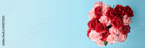artificial red and pink roses in blue background to celebrate anniversary, happy valentine 's day or mother day wallpaper, flyers, invitation, posters, brochure, banners