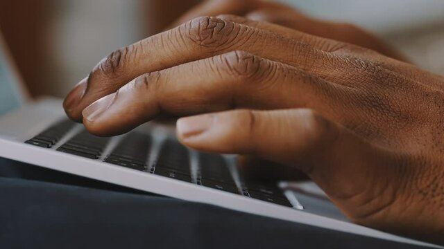 Male african american man hands typing on laptop keyboard Close up. High quality 4k footage