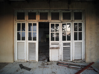 Old wooden doors with glass abandoned and destroyed house..