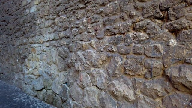 Ancient stone medieval wall. An element of ancient architecture.