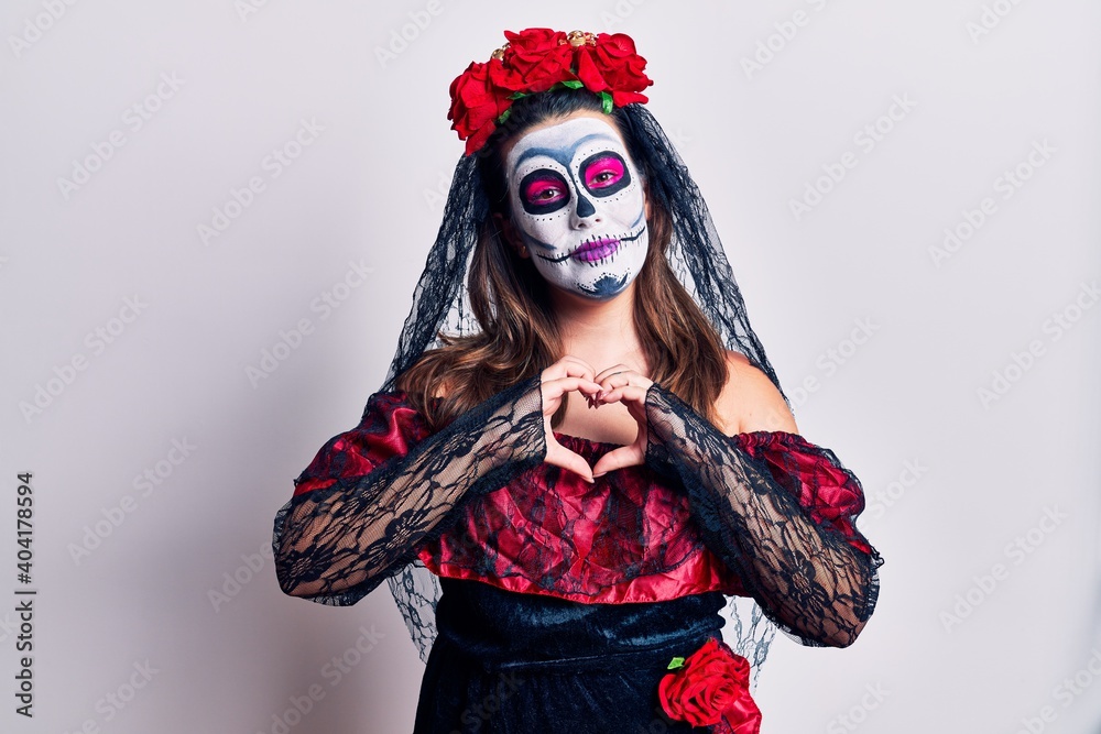 Poster young woman wearing day of the dead costume over white smiling in love doing heart symbol shape with