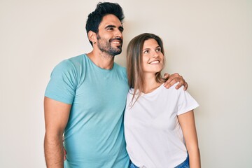 Naklejka premium Beautiful young couple of boyfriend and girlfriend together looking away to side with smile on face, natural expression. laughing confident.