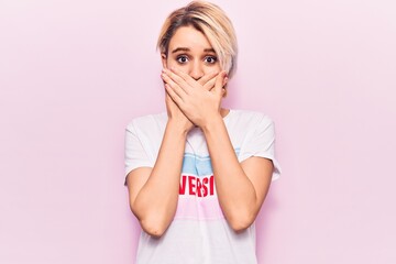 Young beautiful blonde woman wearing t shirt with diversity word message shocked covering mouth with hands for mistake. secret concept.