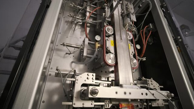Snack pouch package filling and sealing machine. Food industry