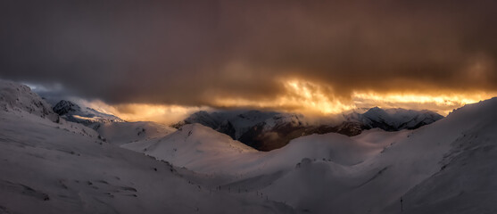 Whistler, British Columbia, Canada. Beautiful Panoramic View of the Canadian Snow Covered Mountain Landscape during a cloudy and vibrant winter sunset. Art Render