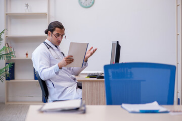 Young male doctor cardiologist working in the clinic