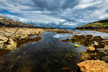 The Atlantic Ocean, dramatic skies and rocky coastline on the west coast of Ireland