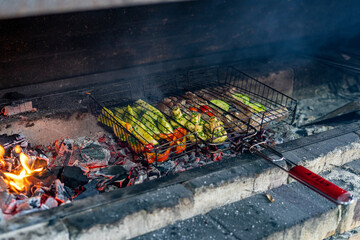 Meat and vegetables are grilled. Cooking on the fire