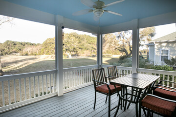 Screen porch with a view of the golf course in the American South.